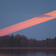 Illustration for article titled Beautiful moon trail photo reveals a red streak across the sky
